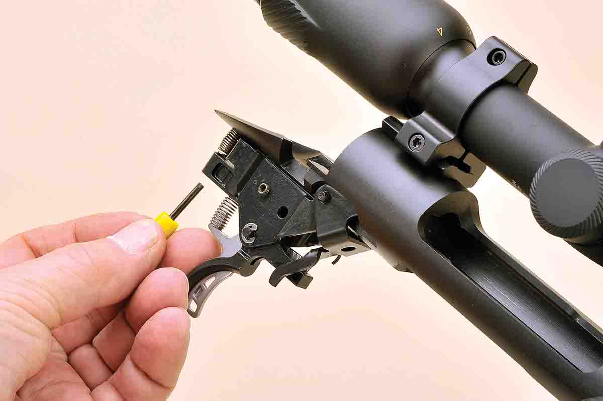 Adjusting the AccuTrigger is easy, and Savage includes a special tool to complete the process. It fits into the rear spring of the trigger assembly after the stock is removed.